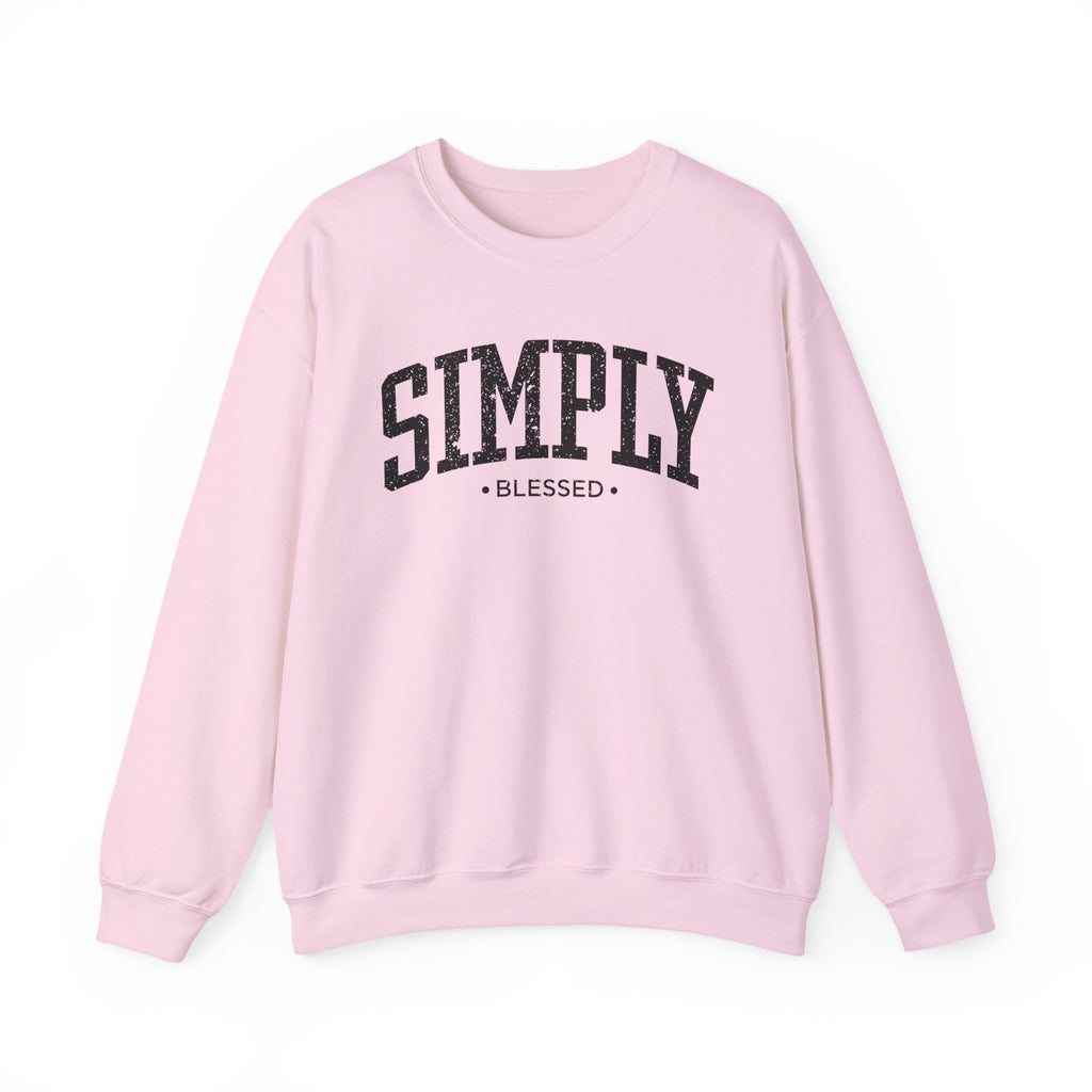 Front view of Light Pink crewneck sweatshirt with black large ‘SIMPLY BLESSED’ text across chest