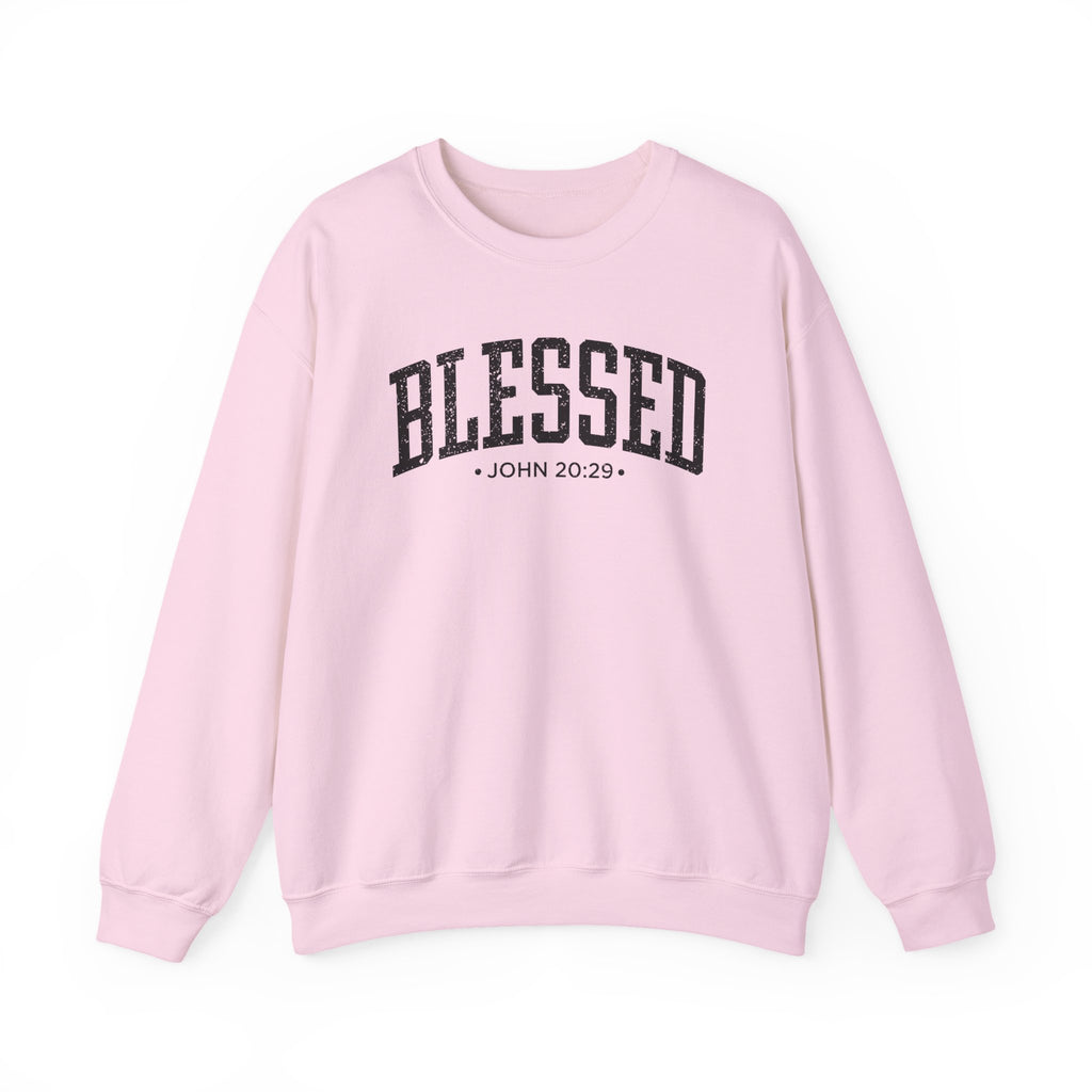 Front view of Light Pink crewneck sweatshirt with black large BLESSED text and John 20:29 below it across chest