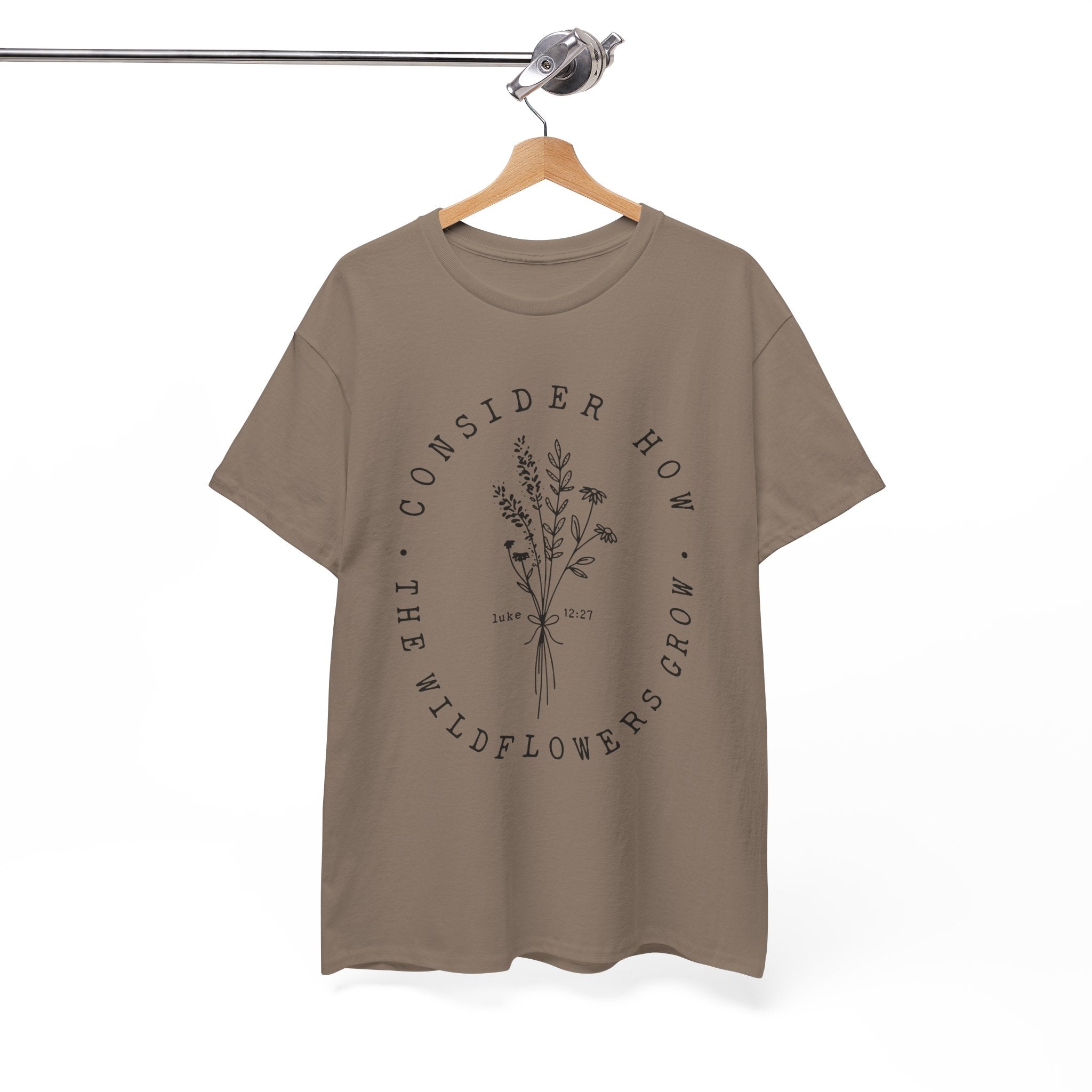 Front view Brown Savana t-shirt with large black floral graphic and Luke 12:27 Bible verse displayed on a hanger