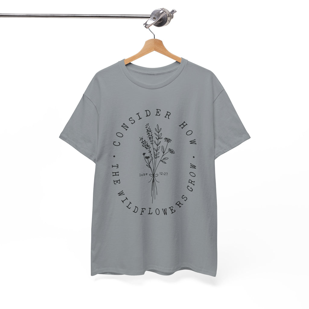 Front view Gravel t-shirt with large black floral graphic and Luke 12:27 Bible verse displayed on a hanger