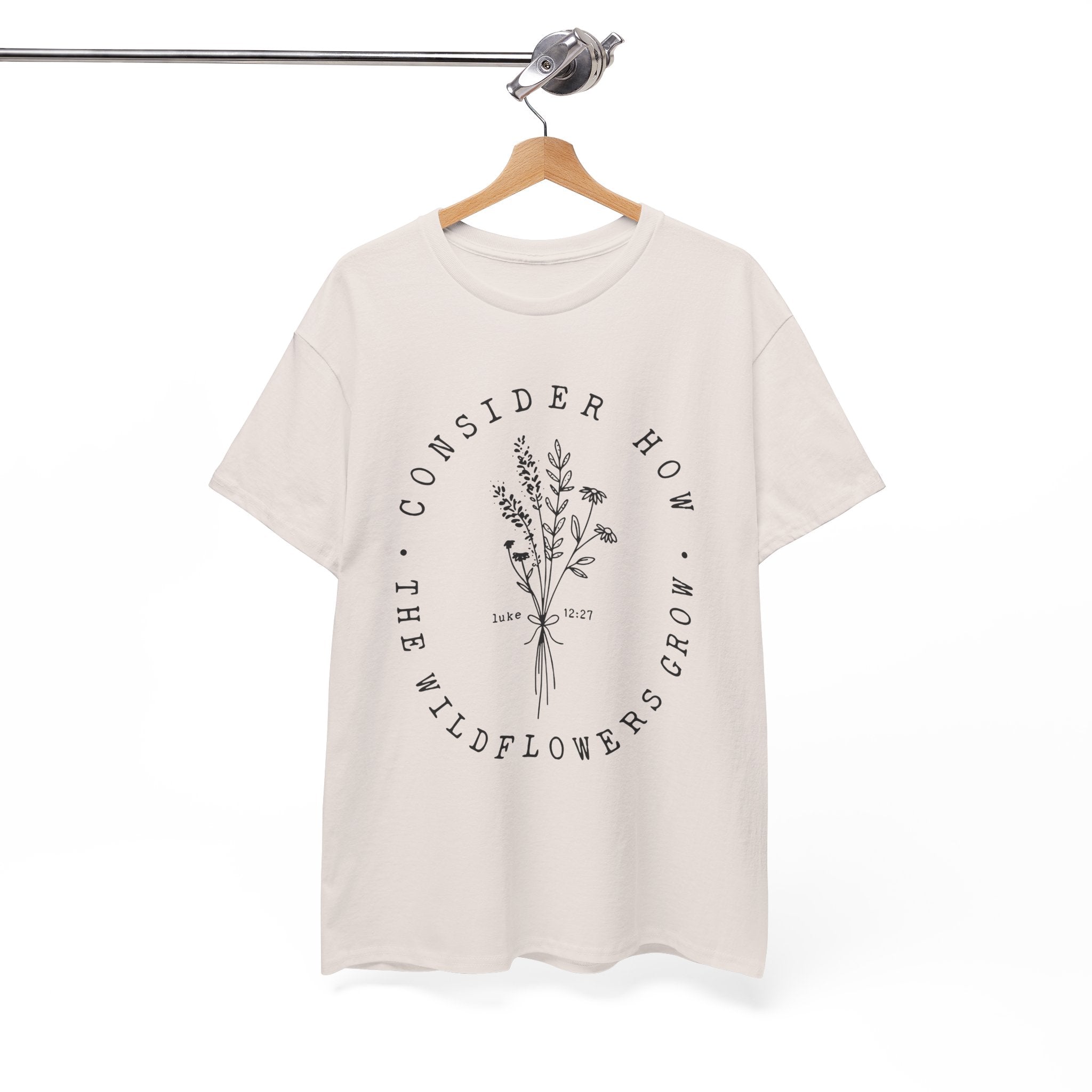 Front view Ice Grey t-shirt with large black floral graphic and Luke 12:27 Bible verse displayed on a hanger