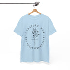 Front view Light Blue t-shirt with large black floral graphic and Luke 12:27 Bible verse displayed on a hanger