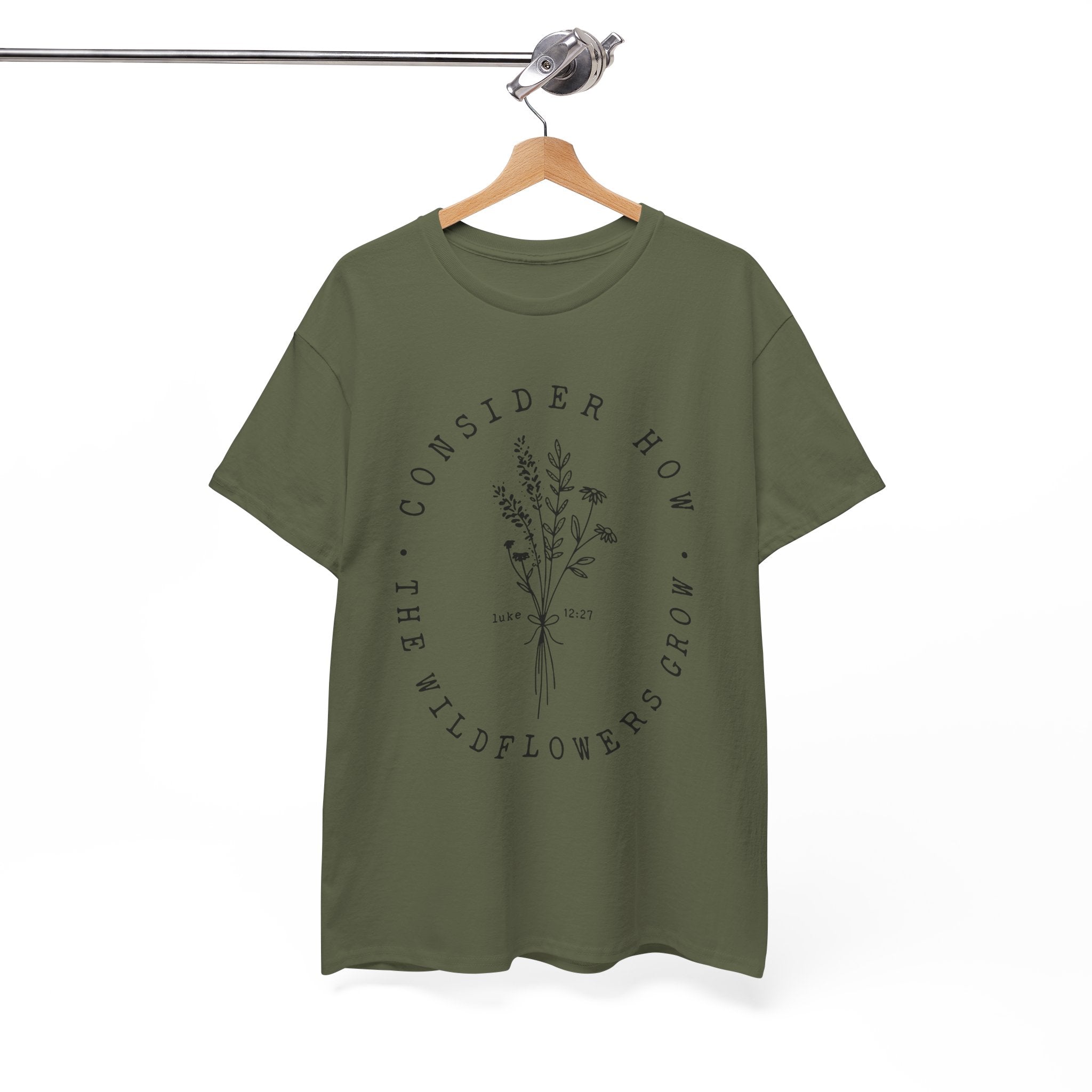 Front view Military Green t-shirt with large black floral graphic and Luke 12:27 Bible verse displayed on a hanger