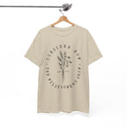 Front view Sand t-shirt with large black floral graphic and Luke 12:27 Bible verse displayed on a hanger