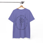 Front view Violet t-shirt with large black floral graphic and Luke 12:27 Bible verse displayed on a hanger
