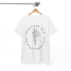 Front view White t-shirt with large black floral graphic and Luke 12:27 Bible verse displayed on a hanger