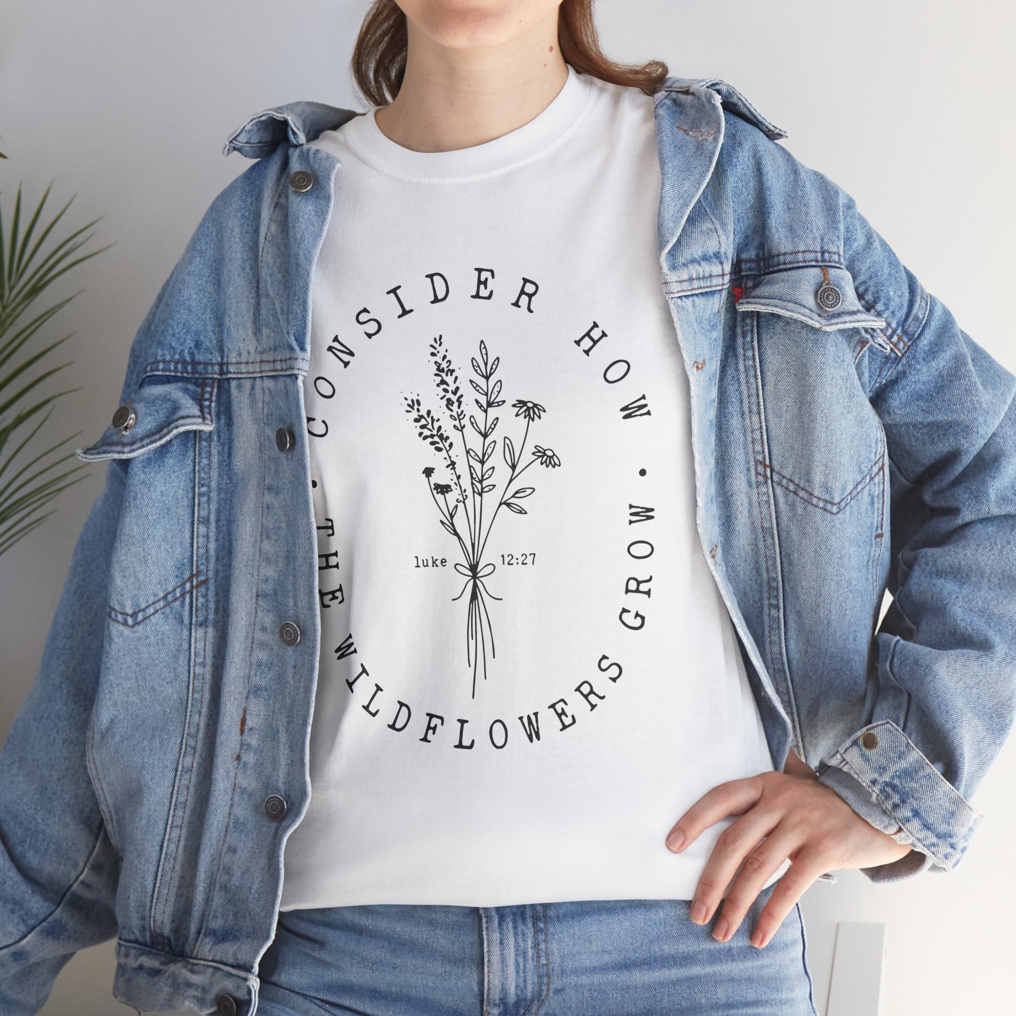 Front view White t-shirt with large black floral graphic and Luke 12:27 Bible verse displayed on model 