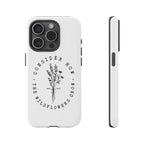 White iPhone case with black floral graphic and Luke 12:27 Bible verse displayed on an iPhone 15 Pro