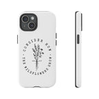 White iPhone case with black floral graphic and Luke 12:27 Bible verse displayed on an iPhone 15