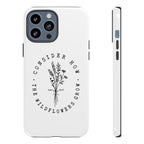 White iPhone case with black floral graphic and Luke 12:27 Bible verse displayed on an iPhone Pro Max