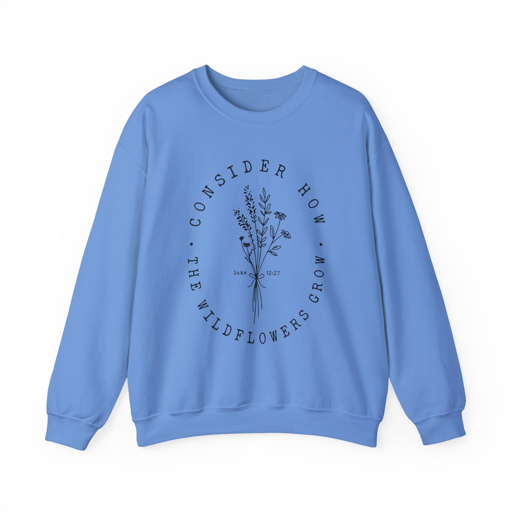 Front view Carolina Blue crewneck sweatshirt black floral graphic and 'Consider How the Wildflowers Grow' text from Bible verse Luke 12:27