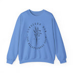 Front view Carolina Blue crewneck sweatshirt black floral graphic and 'Consider How the Wildflowers Grow' text from Bible verse Luke 12:27