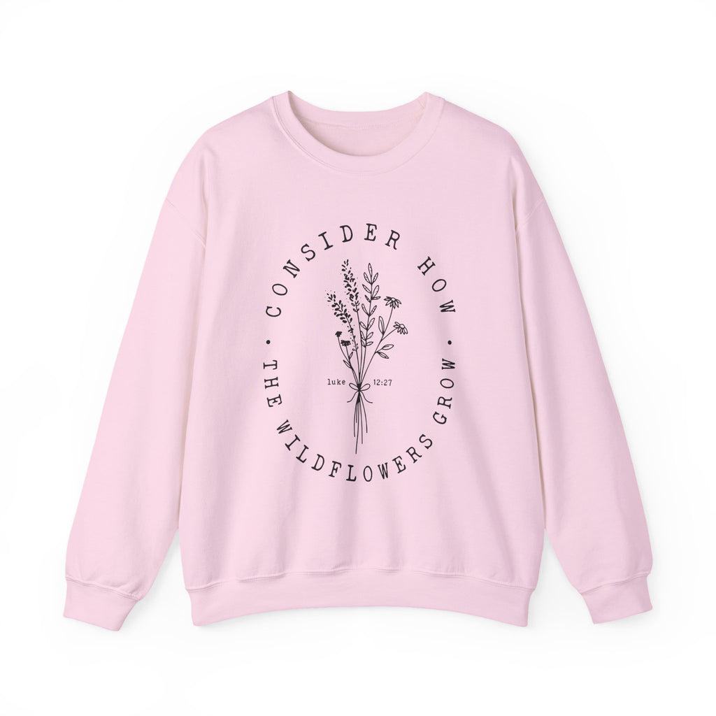 Front view Light Pink crewneck sweatshirt black floral graphic and 'Consider How the Wildflowers Grow' text from Bible verse Luke 12:27