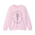 Front view Light Pink crewneck sweatshirt black floral graphic and 'Consider How the Wildflowers Grow' text from Bible verse Luke 12:27