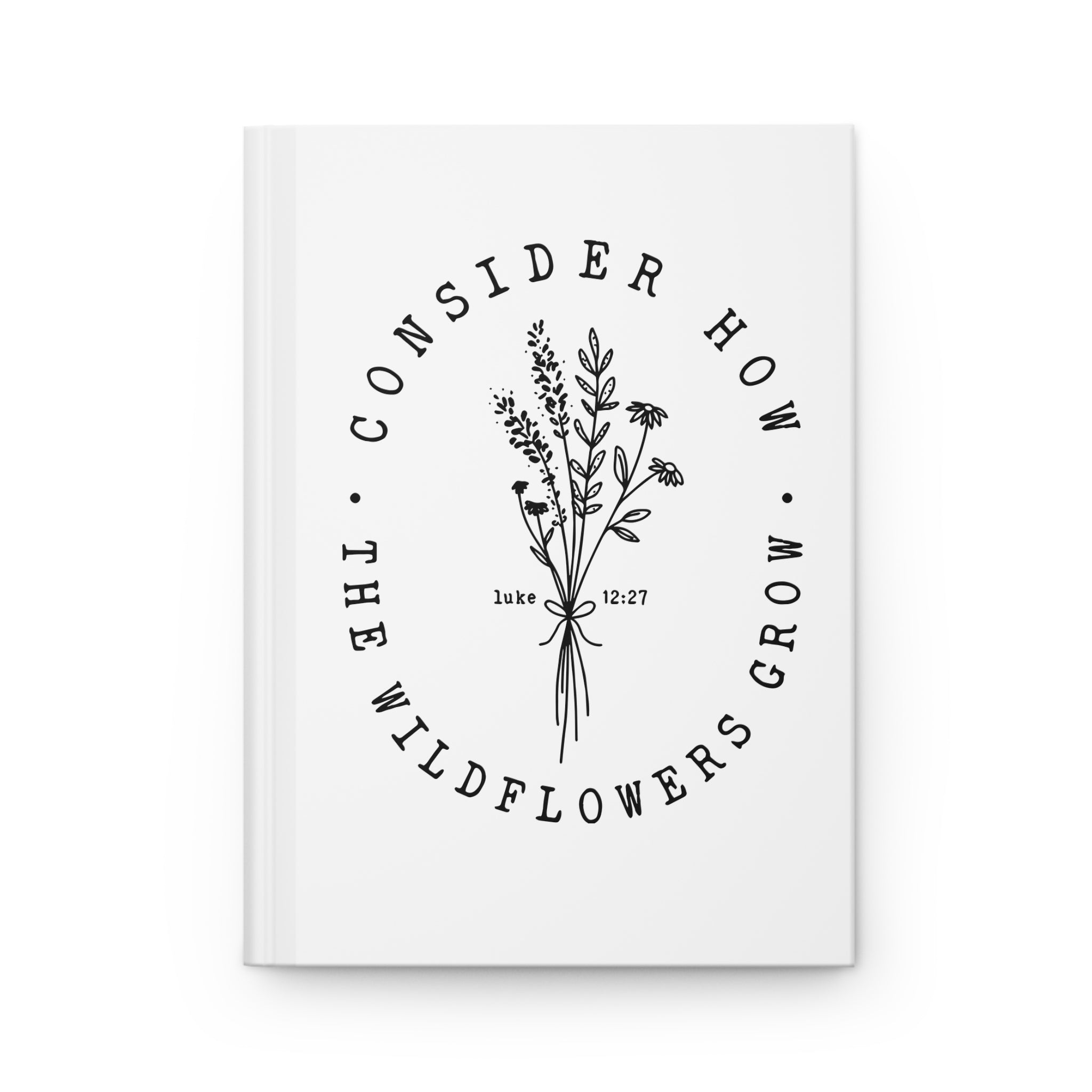 front view of white hardcover journal with black floral graphic and Bible verse from Luke 12:27 