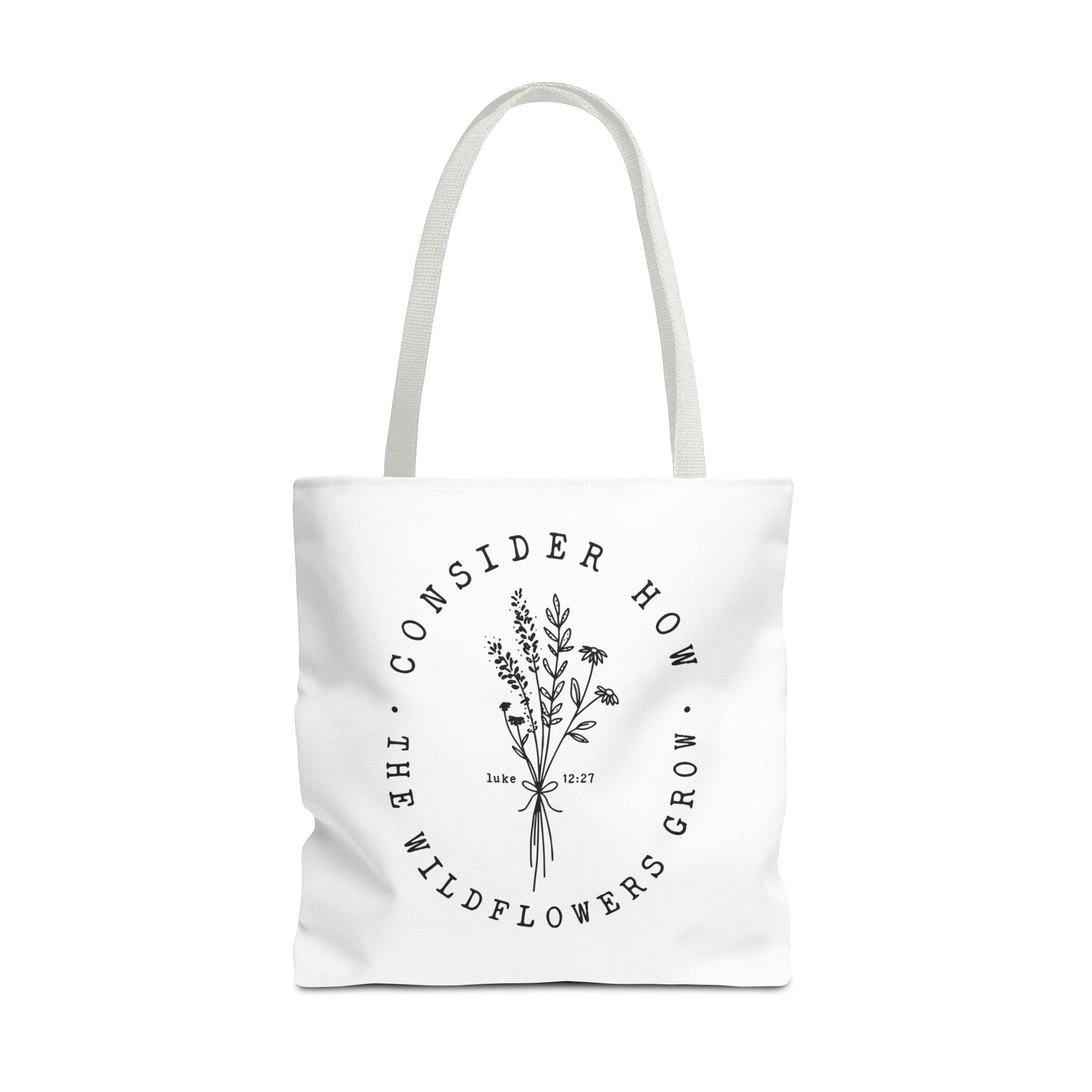 Front view of large White tote bag with white handles and large black floral graphic and Luke 12:27 Bible verse