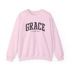 Front view of Light Pink crewneck sweatshirt with black large GRACE text and 2 COR 12:9 below it across chest