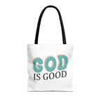 Front view of medium White tote bag with black handles and colorful graphic that says God is Good