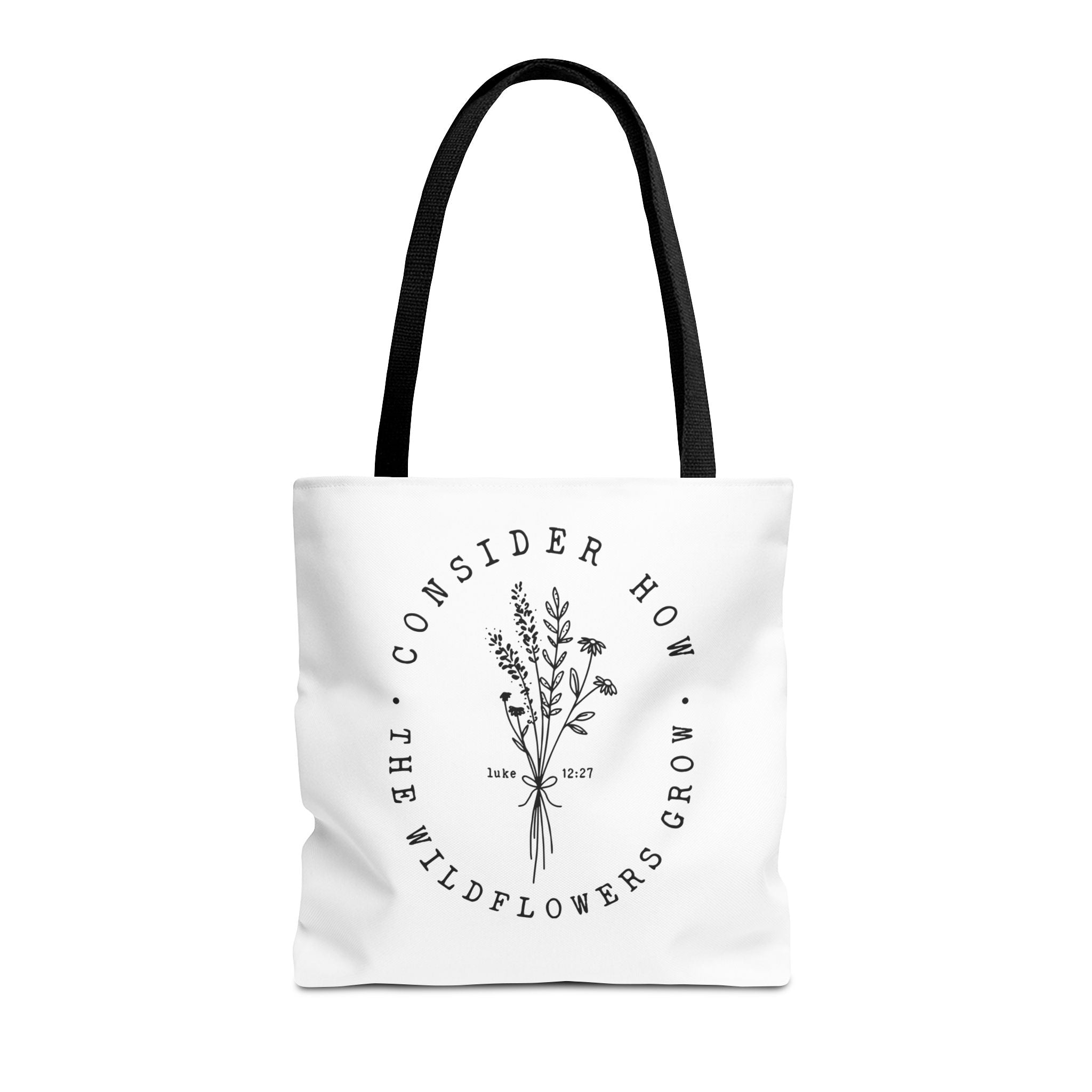 Front view of medium White tote bag with black handles and large black floral graphic and Luke 12:27 Bible verse