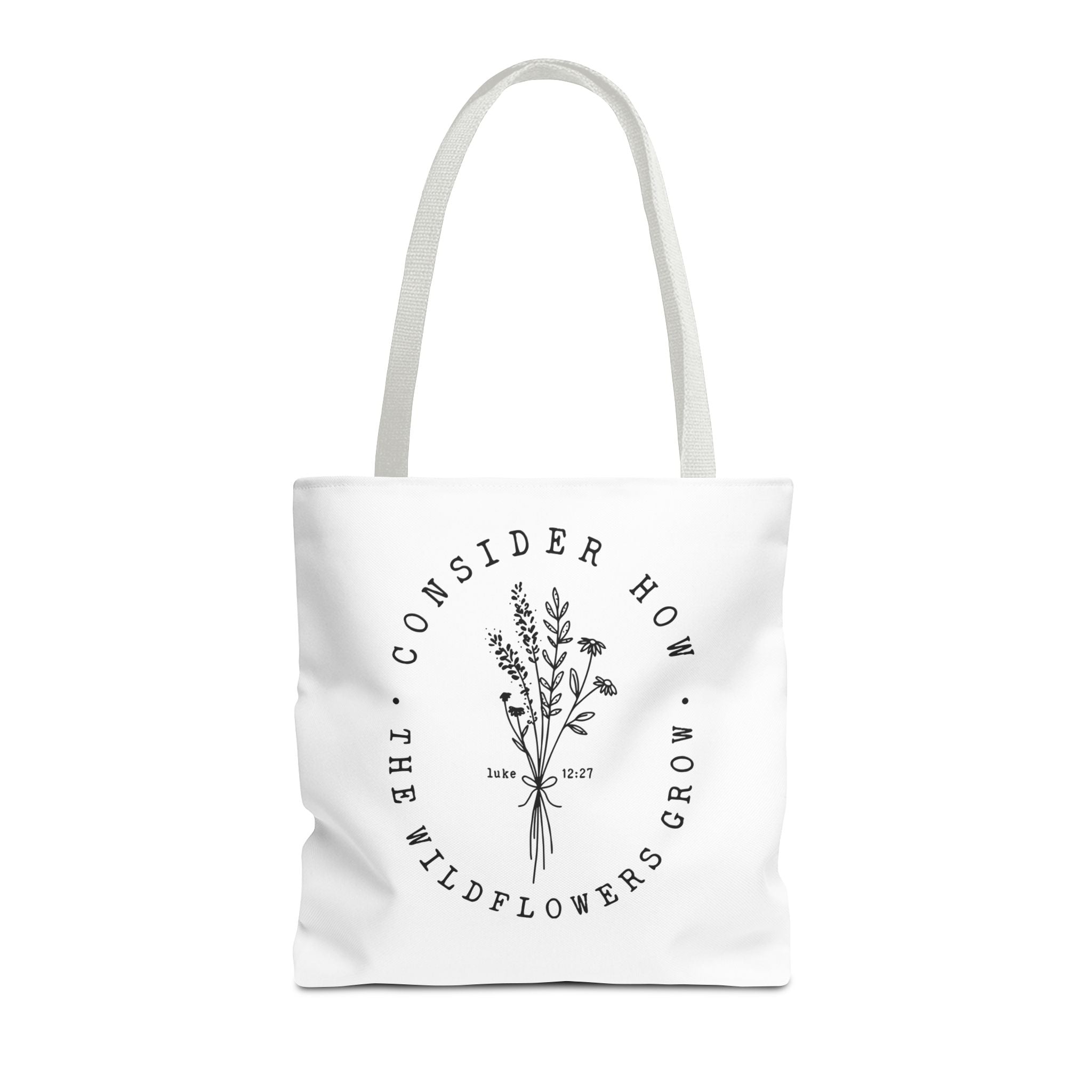 Front view of medium White tote bag with white handles and large black floral graphic and Luke 12:27 Bible verse