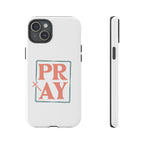 White iPhone case with pink text graphic that says PRAY displayed on an iPhone 15 Plus
