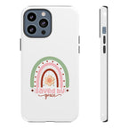White iPhone case with rainbow graphic saying Saved by Grace displayed on an iPhone 13 Pro Max