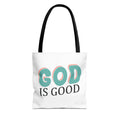 Front view of small White tote bag with black handles and colorful graphic that says God is Good
