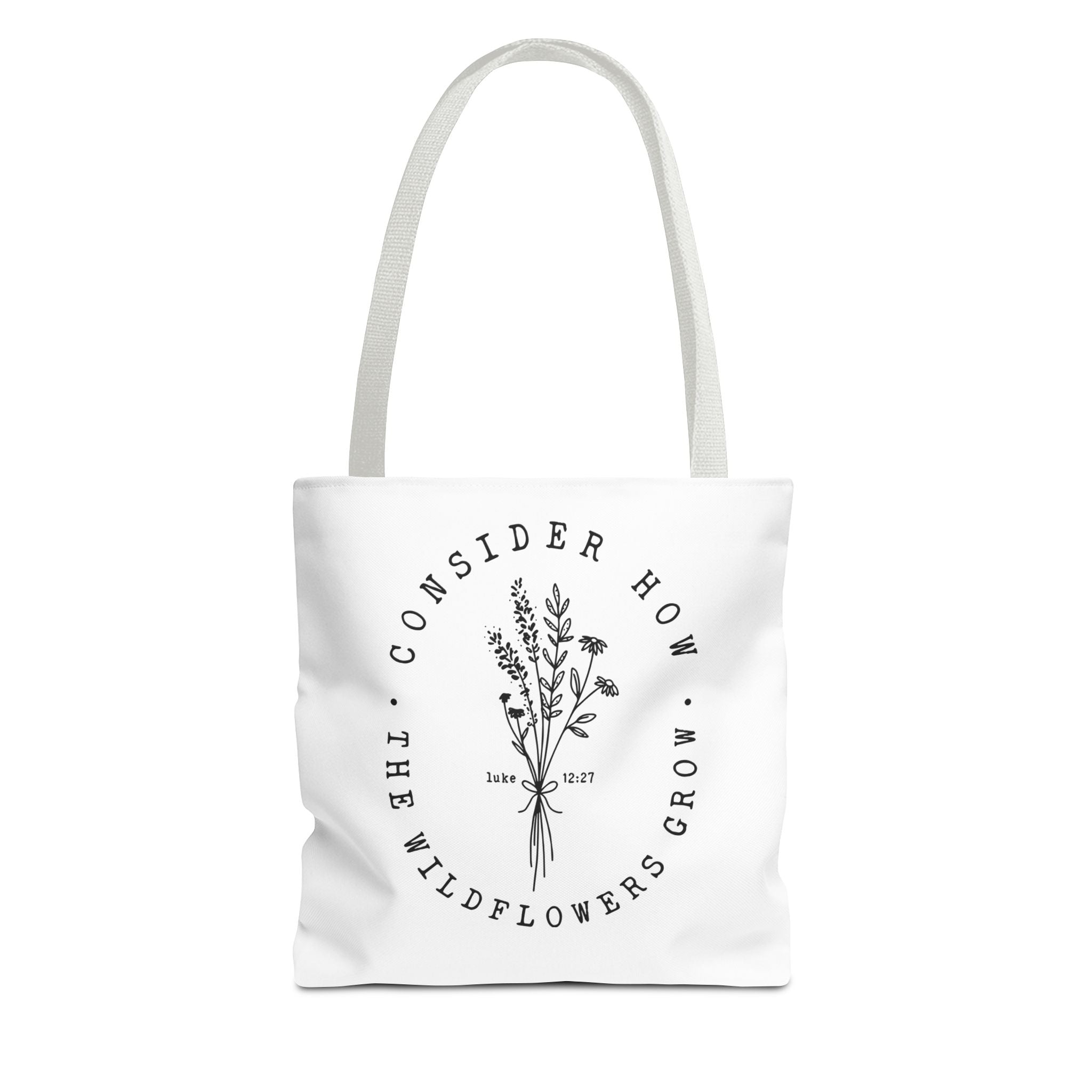 Front view of small White tote bag with white handles and large black floral graphic and Luke 12:27 Bible verse