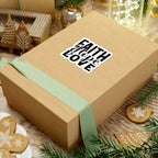 Sticker with black graphic and text saying Faith Hope Love. Displayed on gift box.