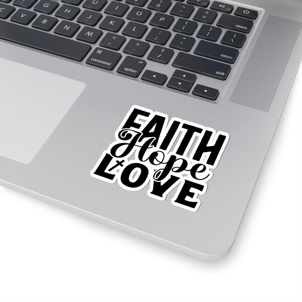 Sticker with black graphic and text saying Faith Hope Love. Displayed on laptop.