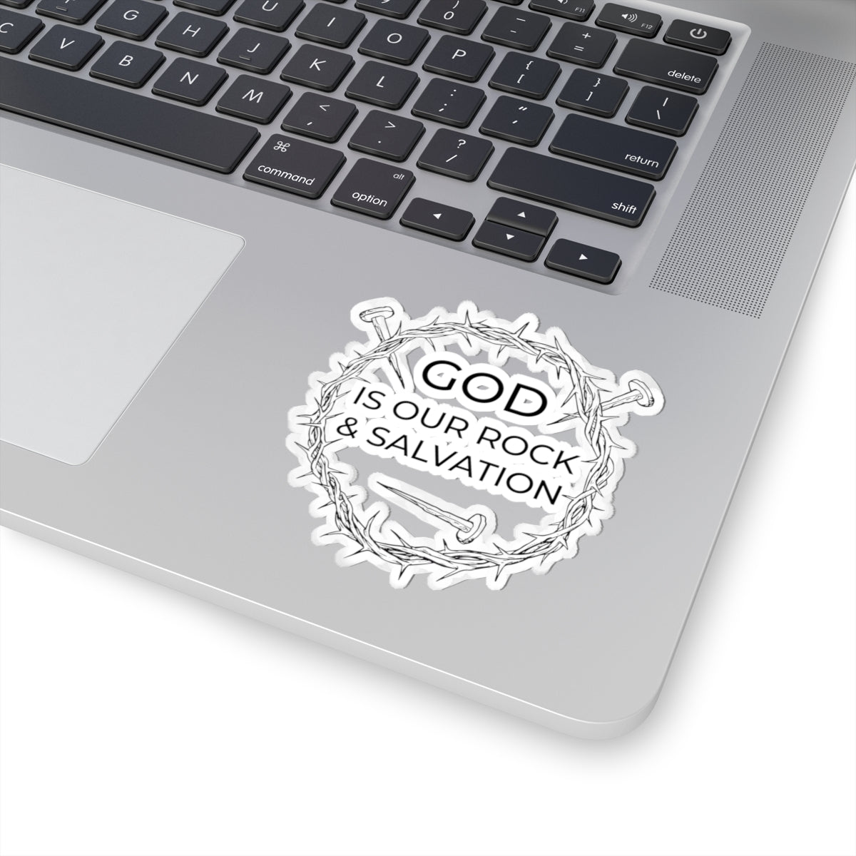 Sticker with black graphic and text saying God Is Our Rock & Salvation. Displayed on laptop.
