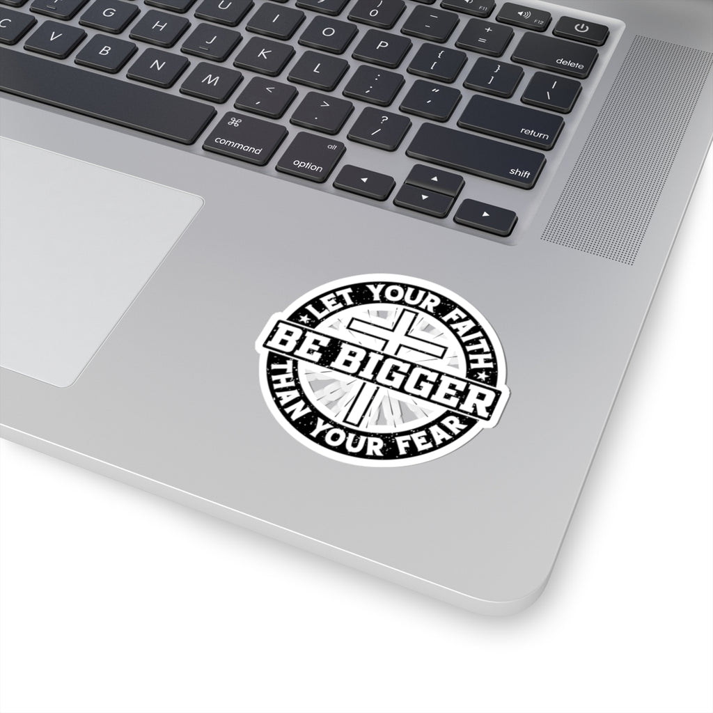Sticker with black text saying Let Your Faith Be Bigger Than Your Fear. Displayed on laptop.
