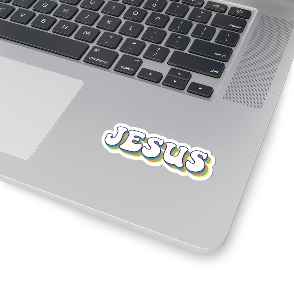 Sticker with retro-style text saying JESUS. Displayed on laptop.