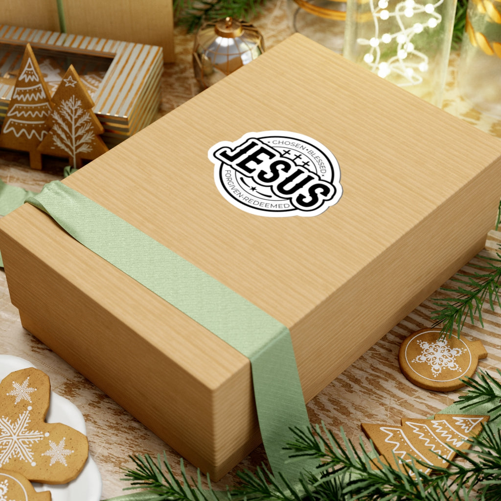 Sticker with large JESUS text surrounded by religious words. Displayed on gift box.