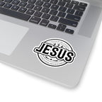 Sticker with large JESUS text surrounded by religious words. Displayed on laptop.